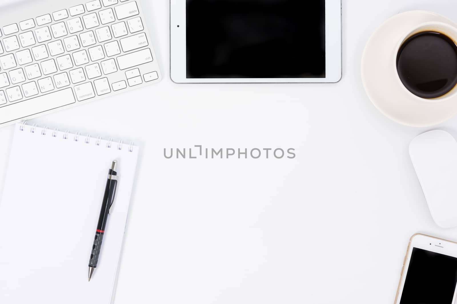 Business desk with a keyboard, mouse and pen on white table