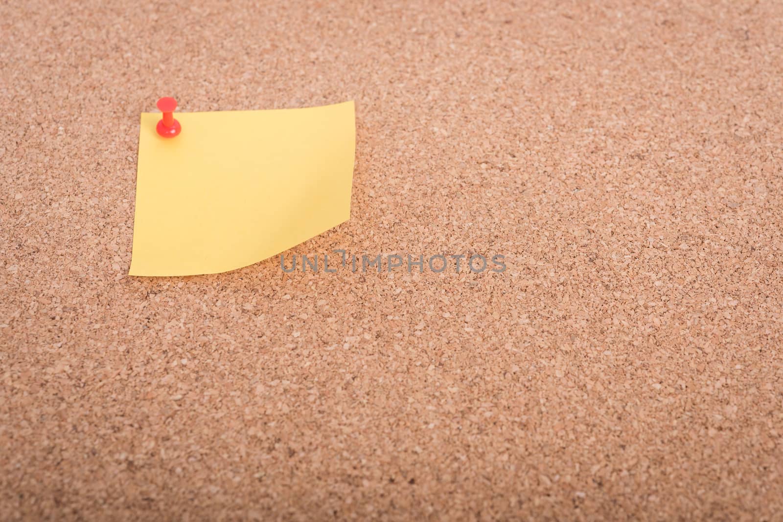 Yellow blank note papers with pin on wooden board background