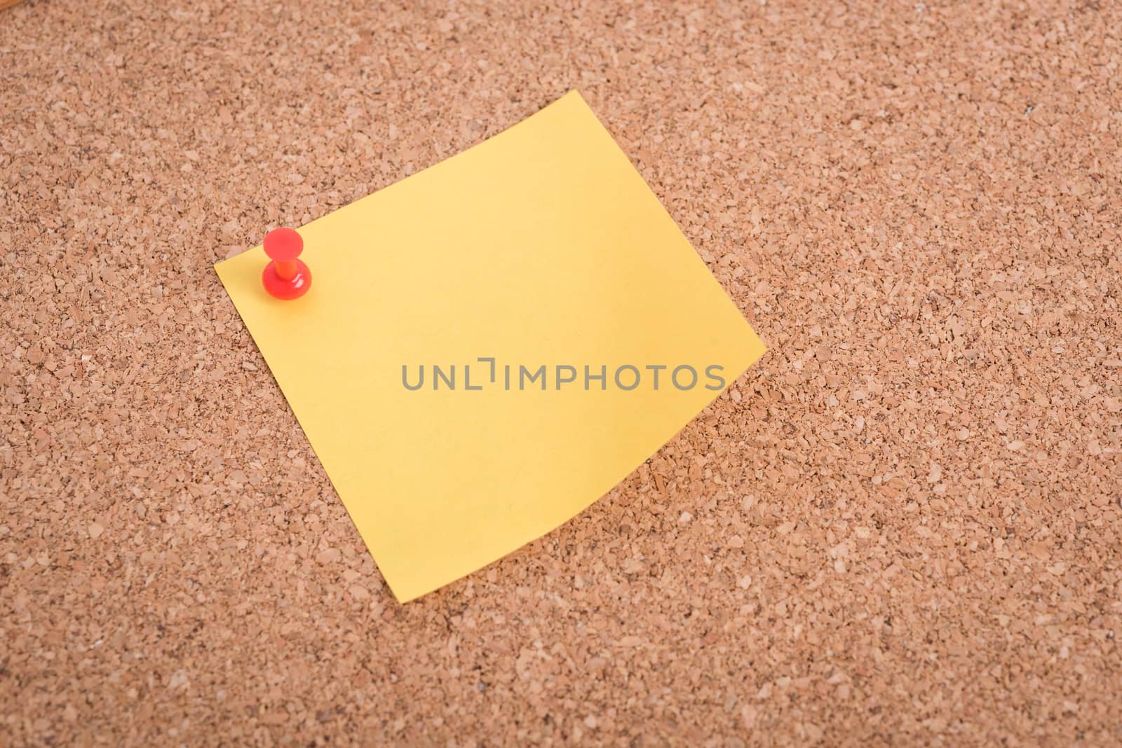 Yellow blank note papers with pin on wooden board background