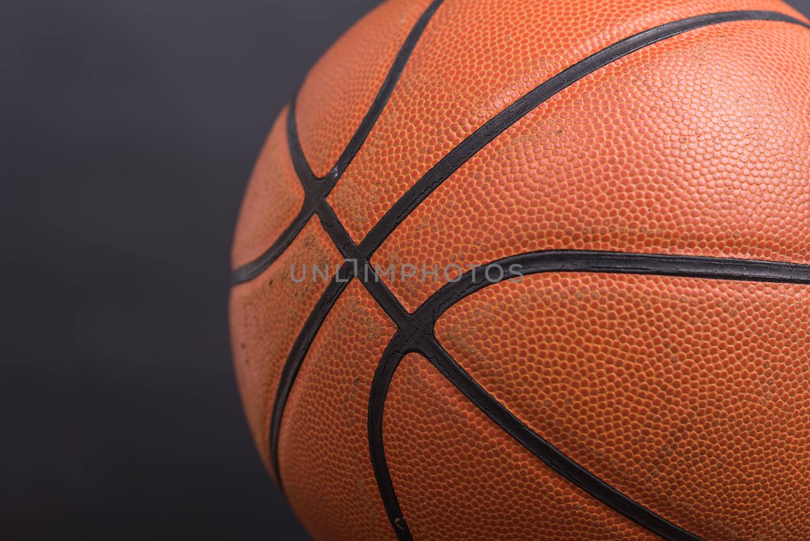 Closeup old basketball basket ball on wooden and black background
