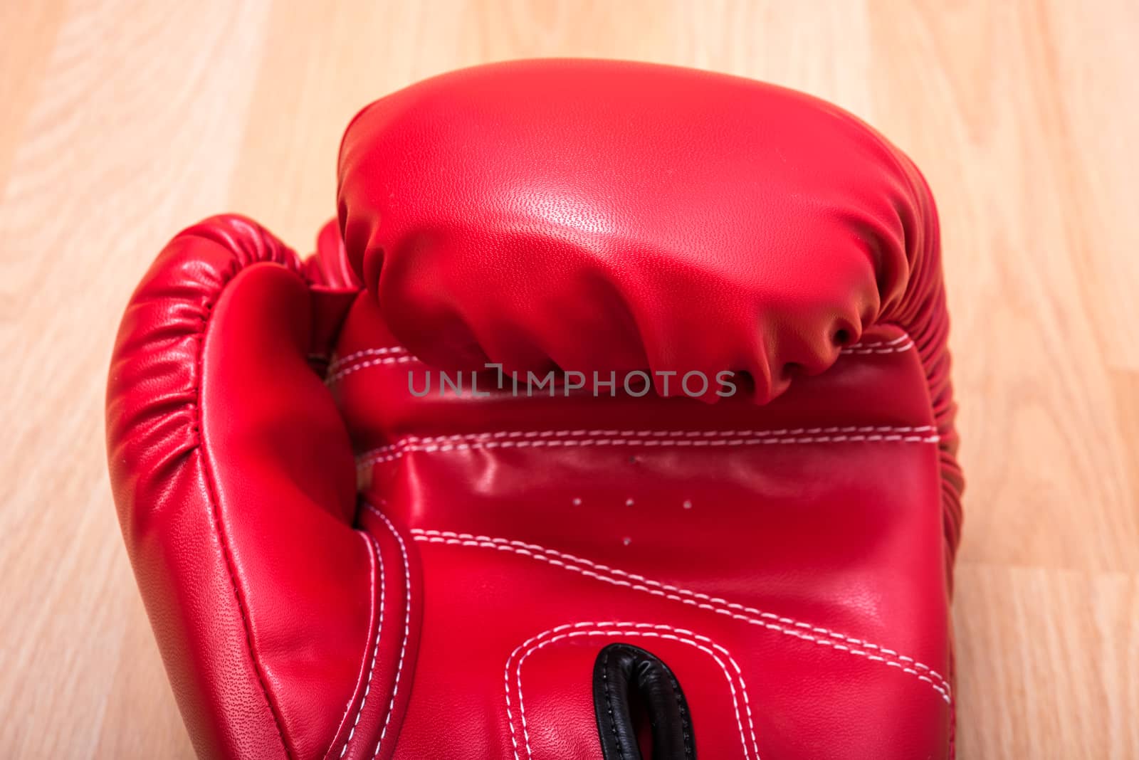 Red boxing gloves on wooden table