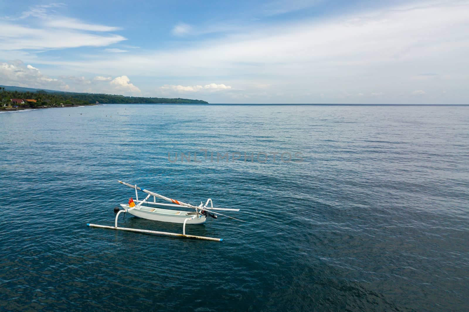 Aerial view of a traditional fishing boat called jukung in Bali, Indonesia.