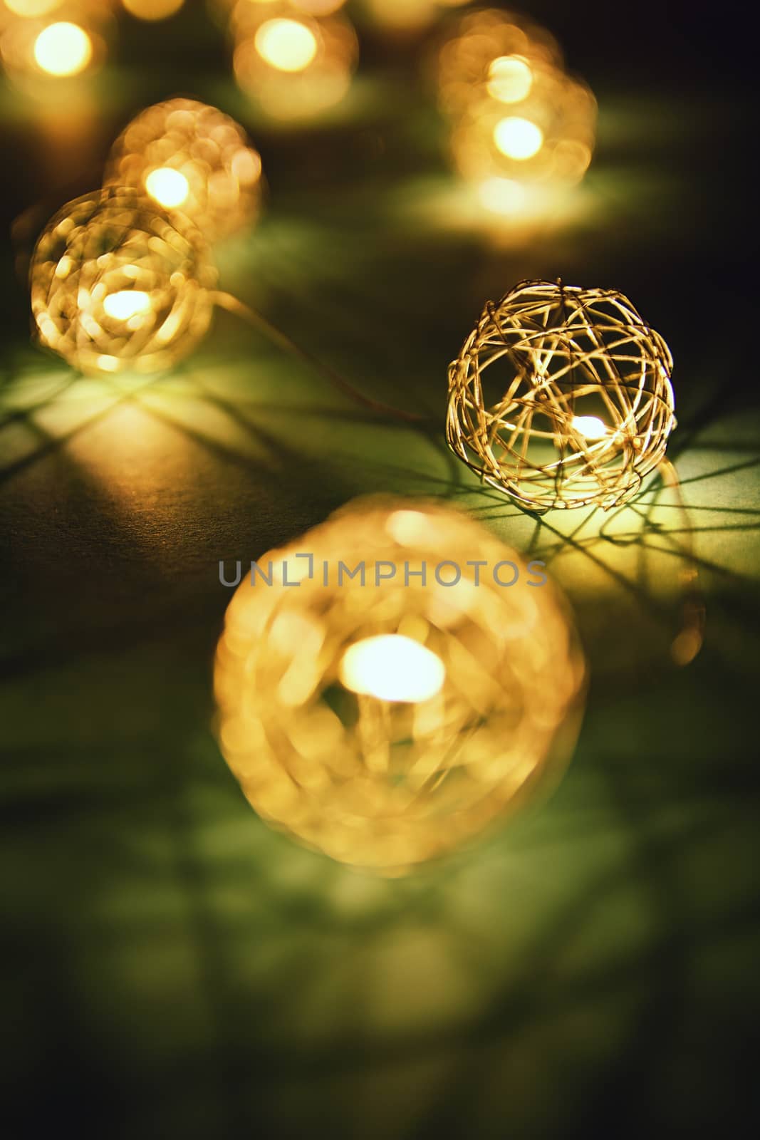 Close up shot of blurred golden Christmas lights making cozy and romantic atmosphere. Festive bukeh background with lights.