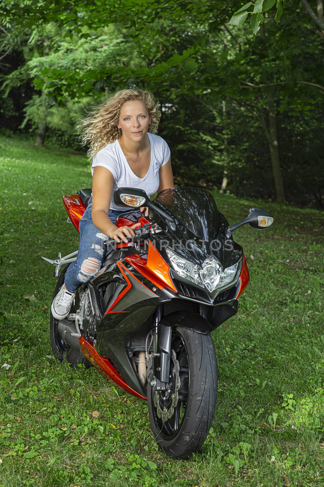 Gorgeous blond woman riding a sport motocycle