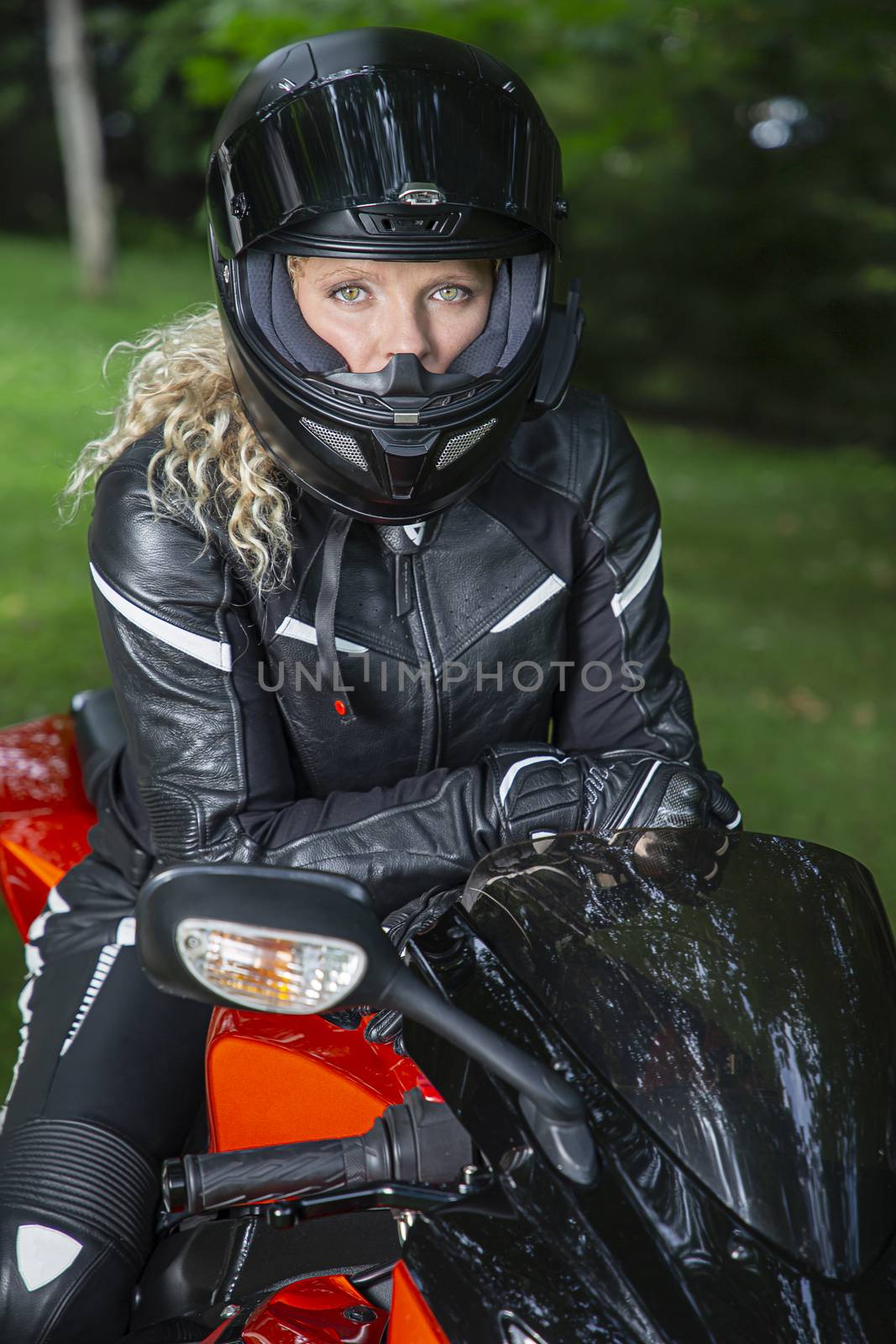 young blond woman full dress in motocyclist gear