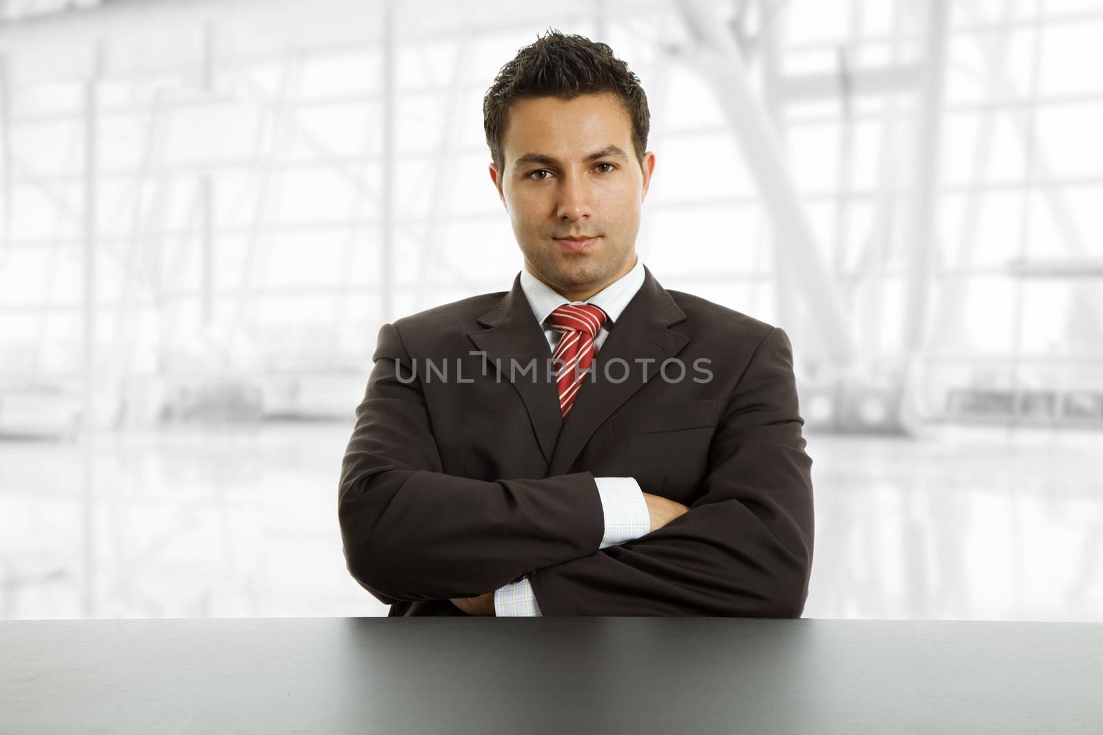 young business man on a desk, isolated on white