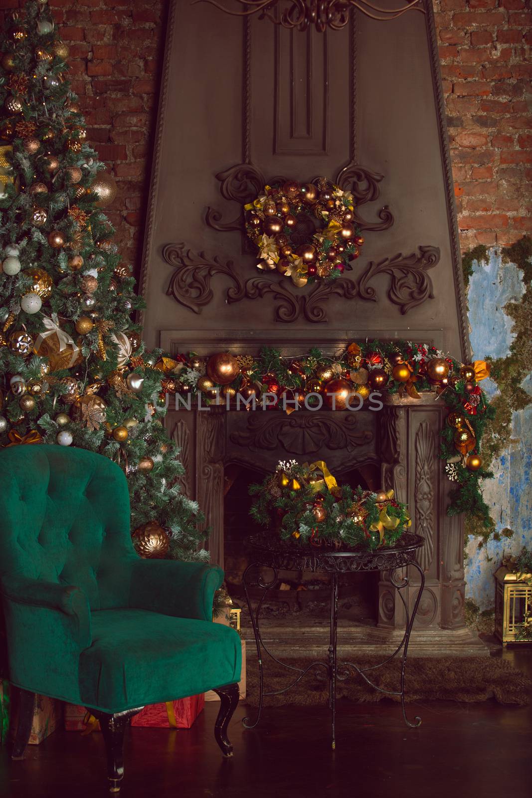 Christmas tree near fireplace and santa claus chair in room