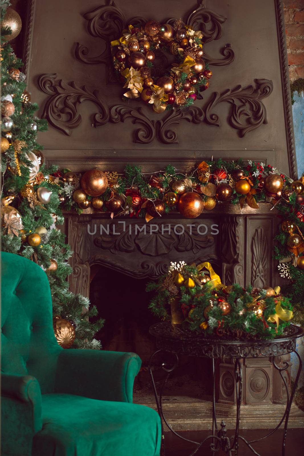 Christmas tree near fireplace and santa claus chair in room