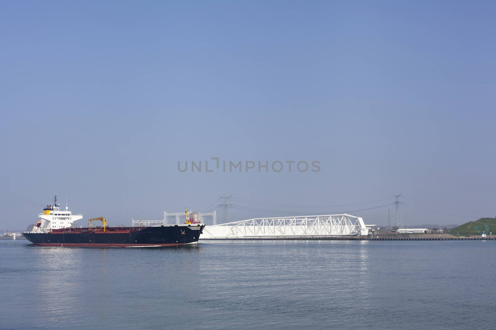 Netherlands, New Waterway. Container ship in front of modern win by Tjeerdkruse