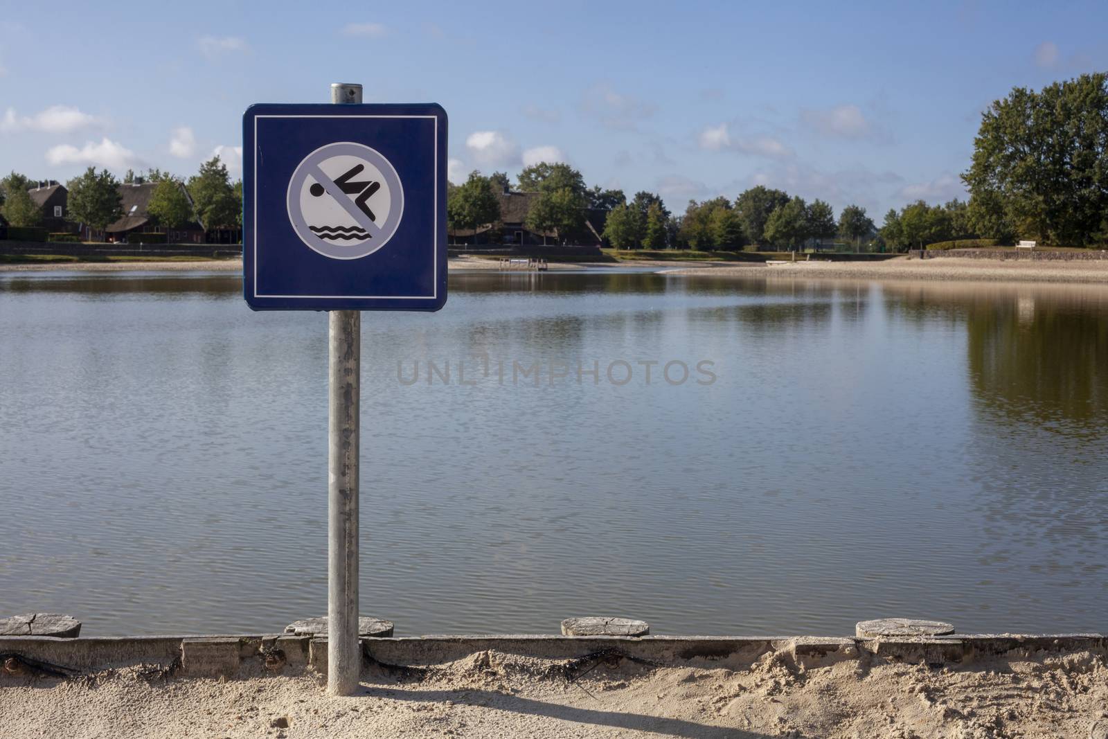 A no swimming danger sign at a lake