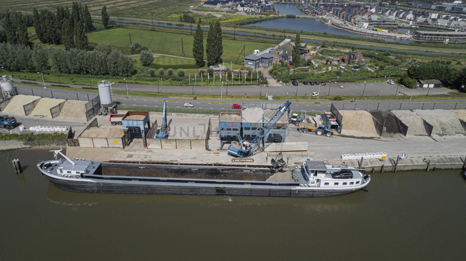 Loading barge with sand and rubble on a small berth. Freight tra by Tjeerdkruse