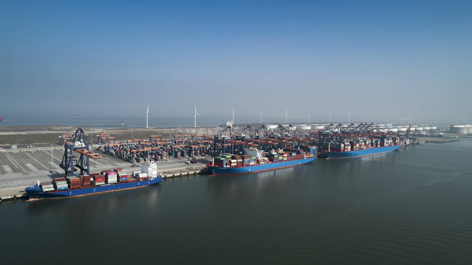 Aerial view of container terminal in the harbor MAASVLAKTE, Netherlands. A large containership from Cosco is unloading