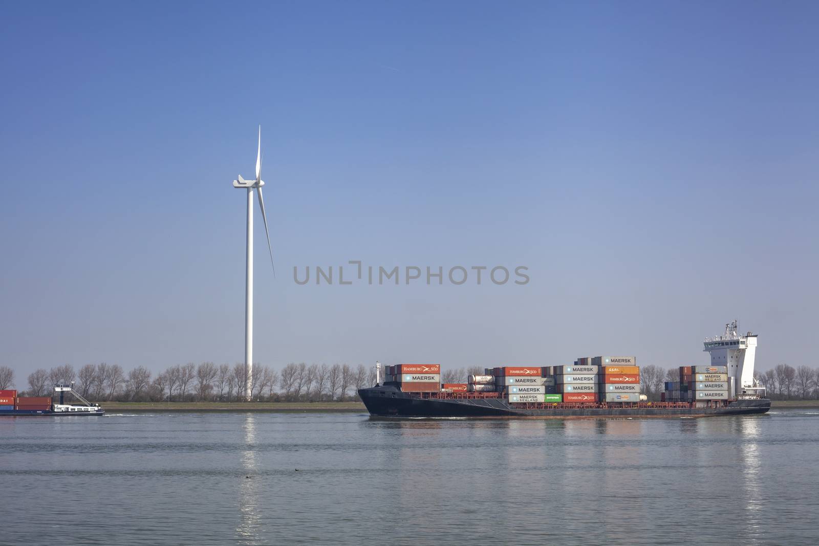 Netherlands, New Waterway. Container ship in front of modern win by Tjeerdkruse