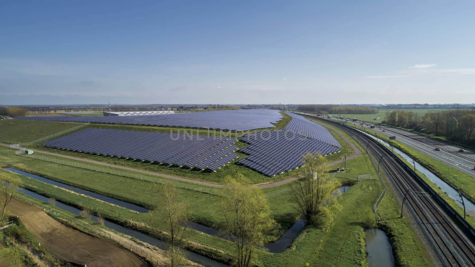 Aerial photography of modern large-scale photovoltaic solar pane by Tjeerdkruse