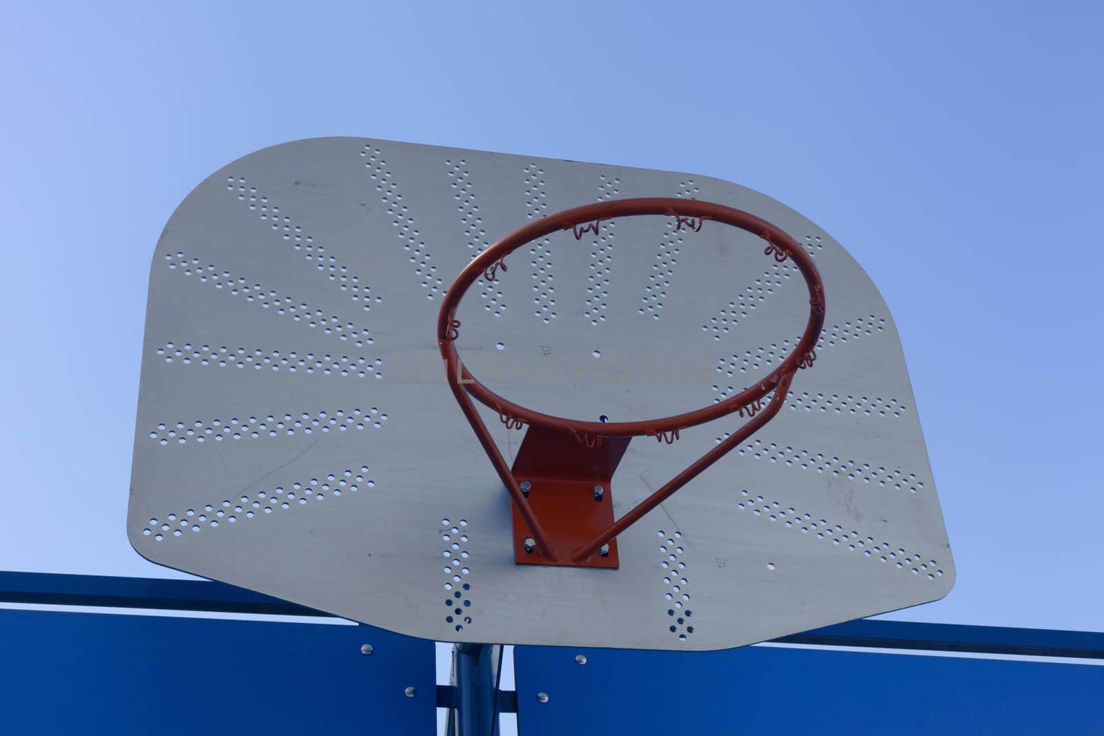 Outdoor basketball hoop against a blue sky - street basketball by Tjeerdkruse