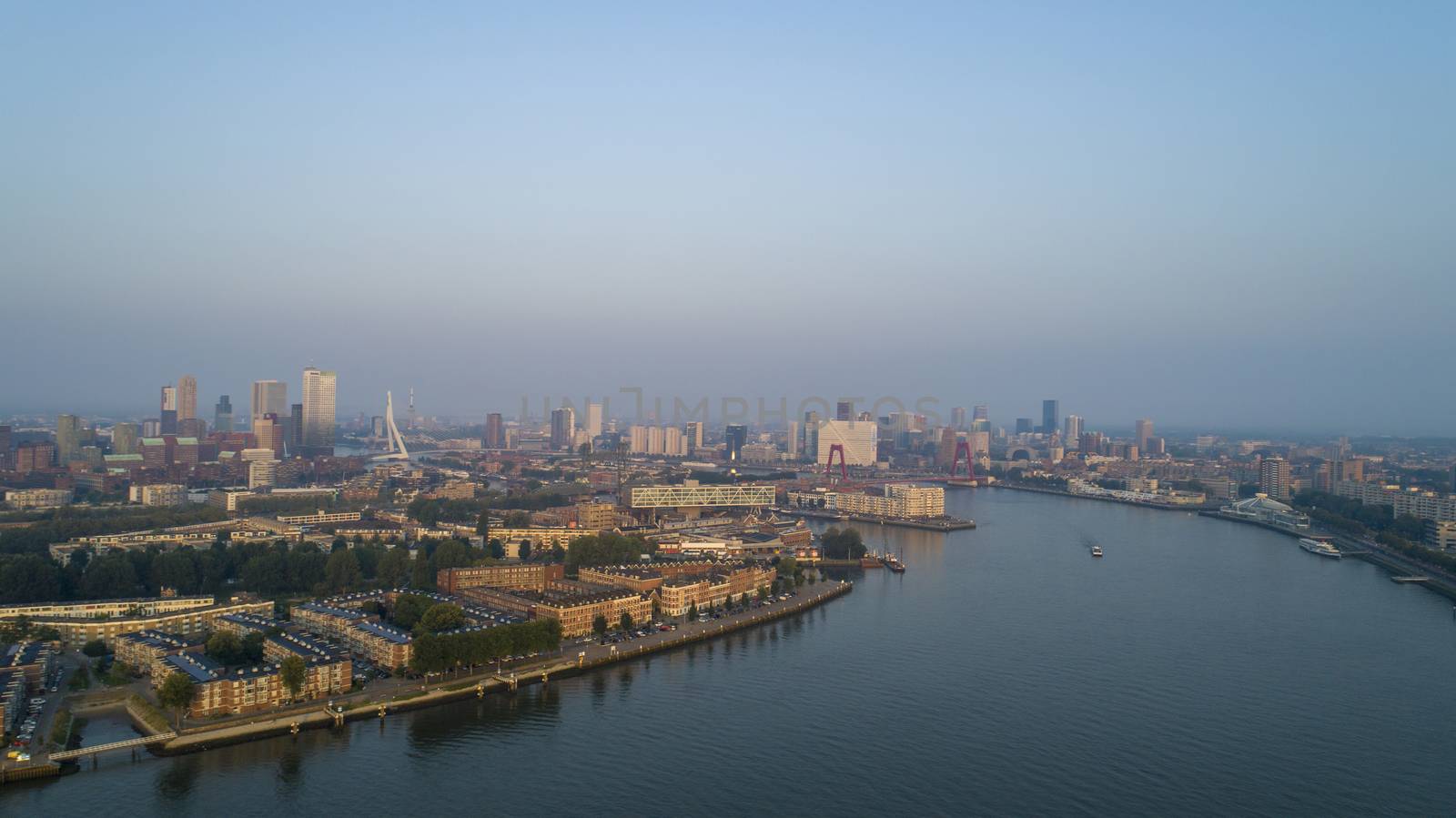 Rotterdam Skyline with Erasmusbrug bridge at sunset in morning in Rotterdam, Netherlands