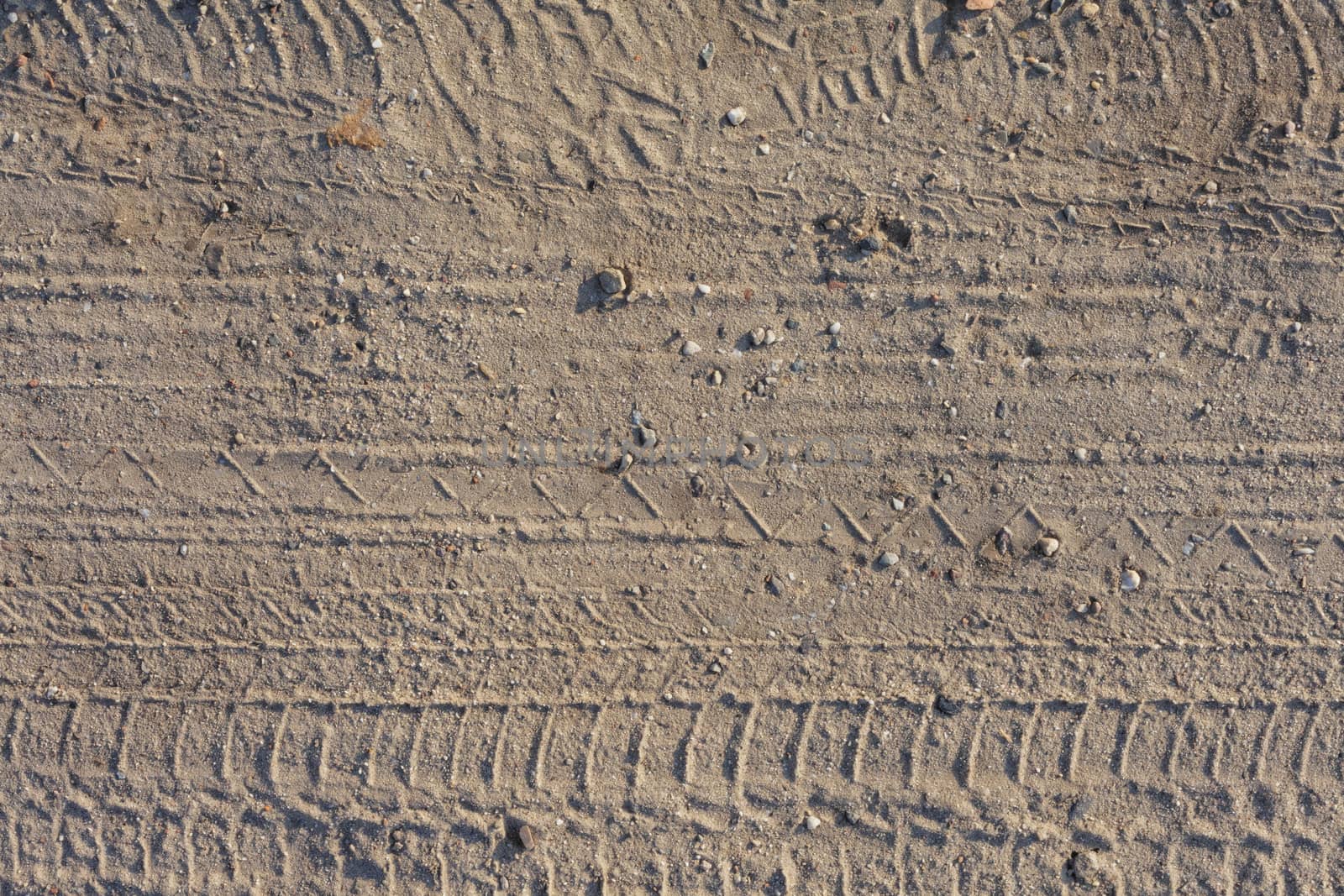 seamless dirt road texture background. Tracks of cars on the sand in the desert sand