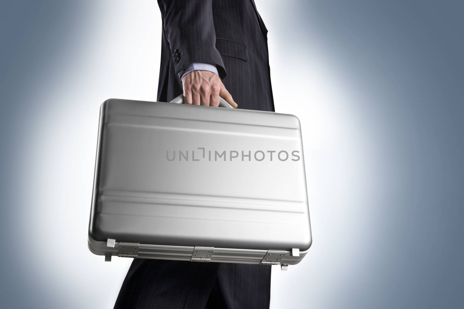 Businessman with a metal suitcase a light blue background