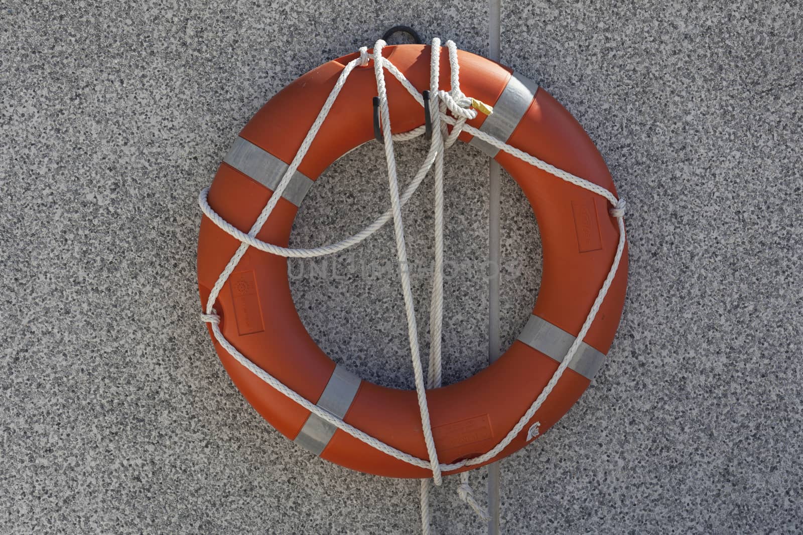 Life buoy hanging on stone wall for emergency