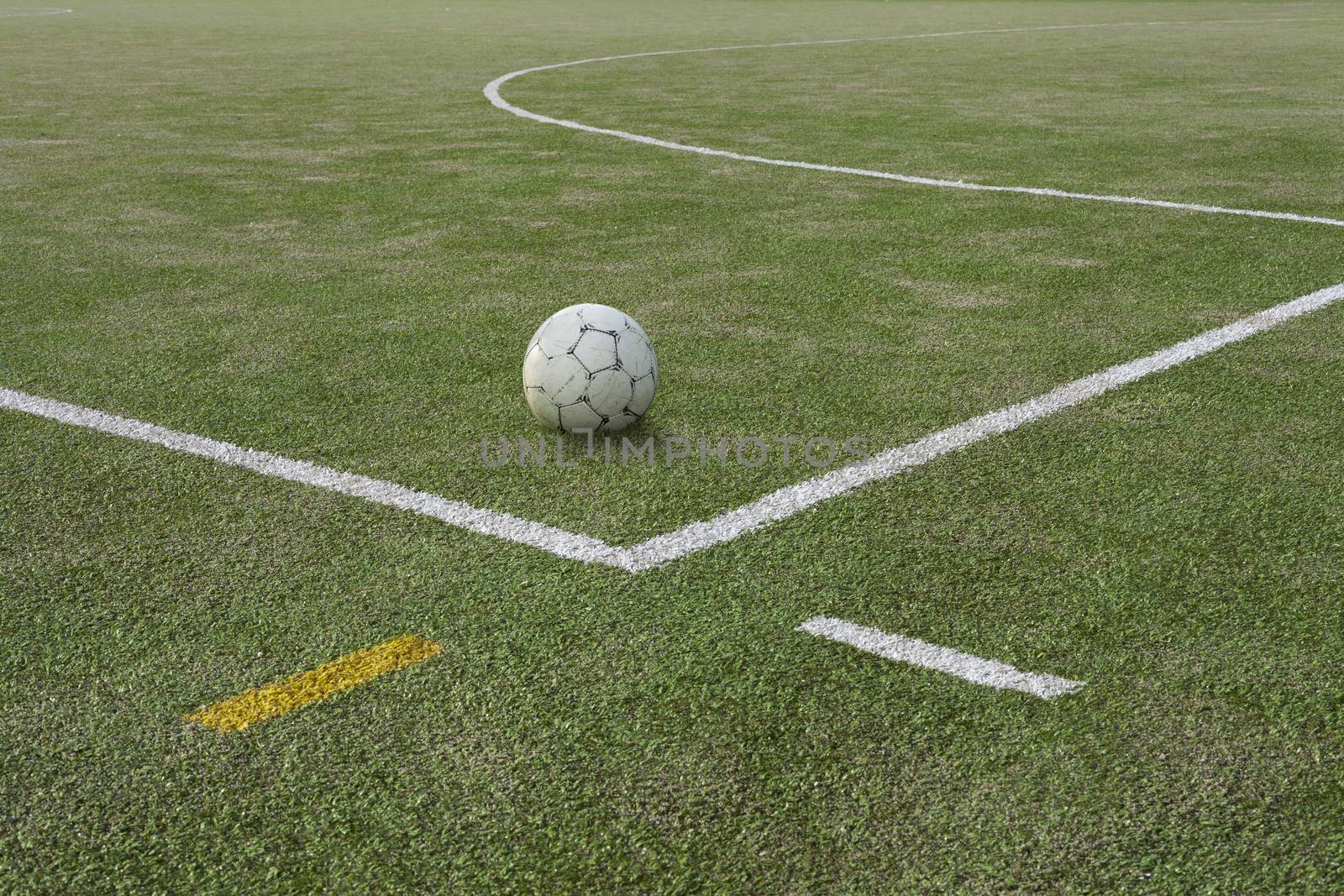 Soccer ball on sports field at boundary line