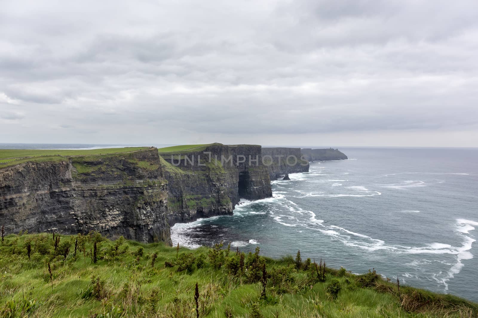 Ireland countryside tourist attraction in County Clare. The Cliffs of Moher and castle Ireland. Epic Irish Landscape UNESCO Global Geopark the wild atlantic way. Beautiful scenic nature Ireland.