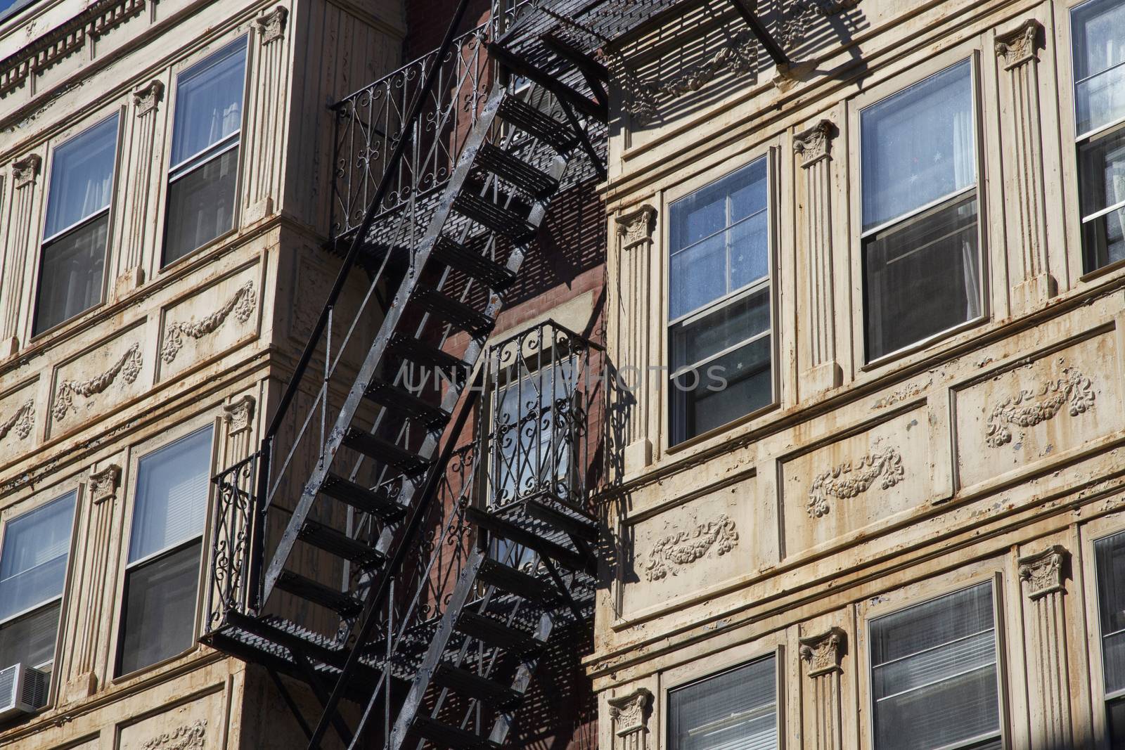 Iron Fire escape stairs-downtown back alley architecture-steel and yellow brick background