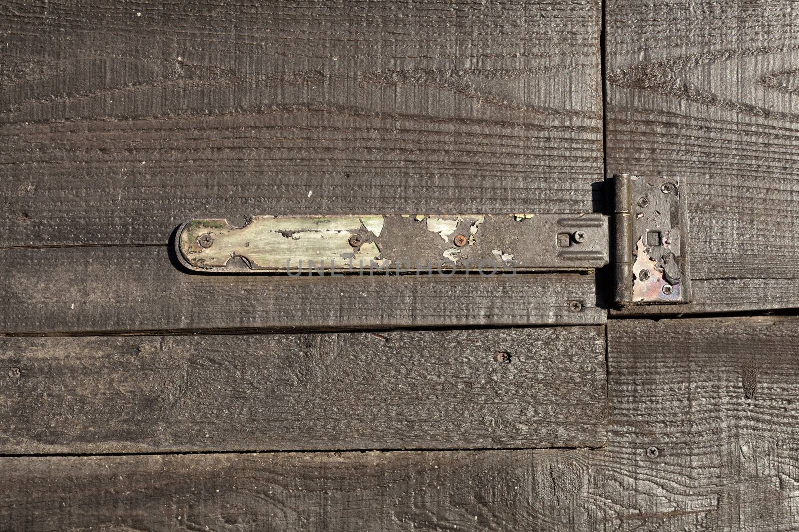 Close up of an old hinge on a wooden door - Image