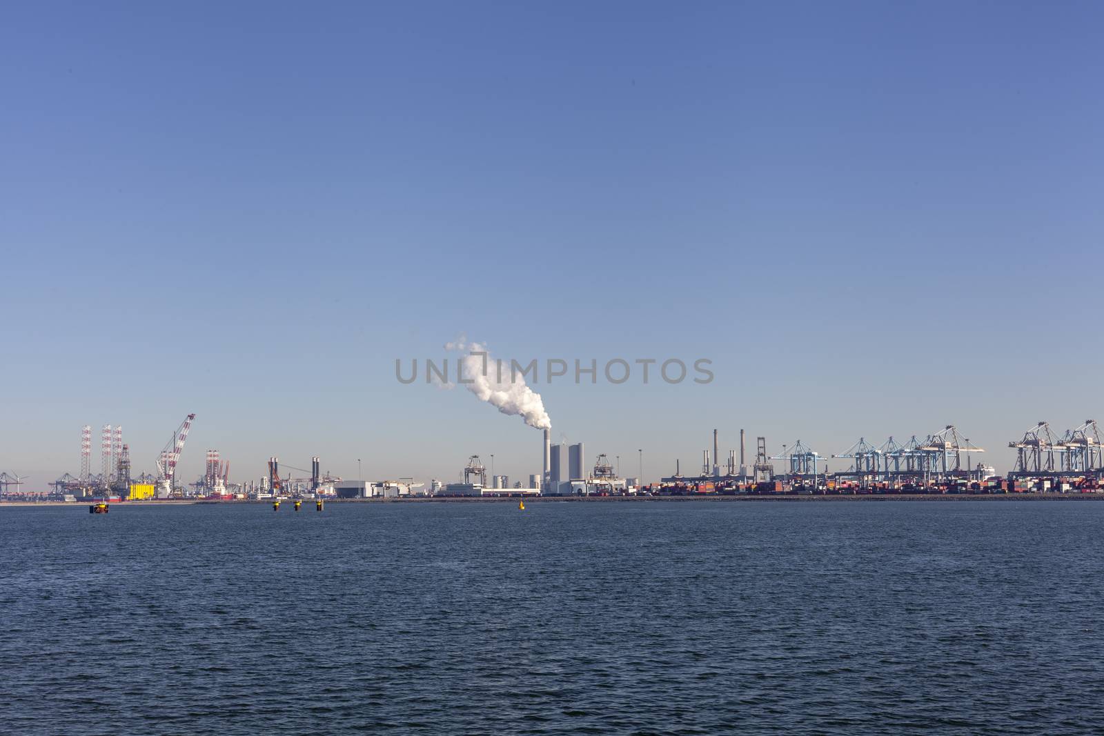 Container ship in export and import business and logistics. Shipping cargo to harbor by crane. Water transport International. Rotterdam, Netherlands