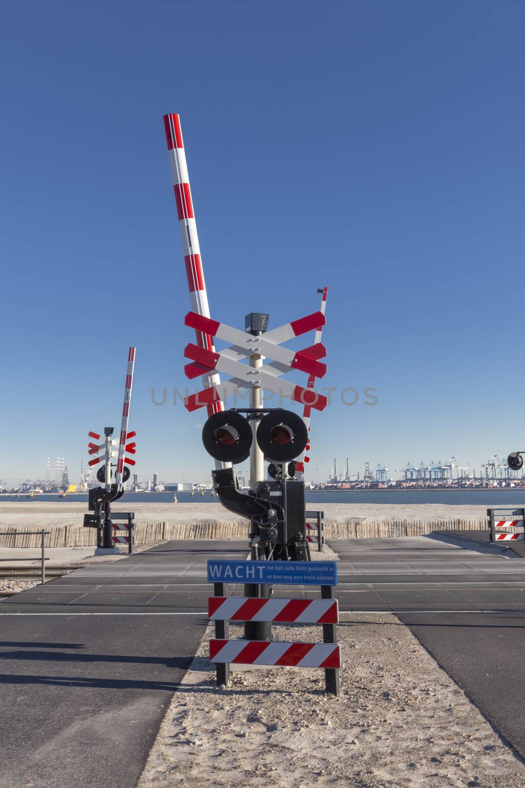 Road signs at the railway crossing with a barrier. Organization of the transport system of a European country. Safety of traffic in road and rail transport, Rotterdam