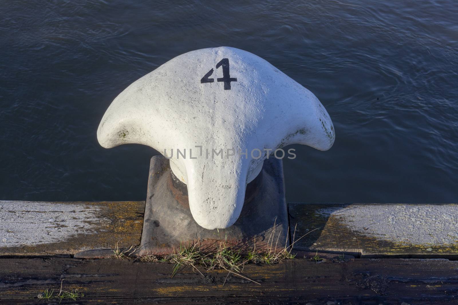 Metal white bollard from Rotterdam harbour with number four - Image