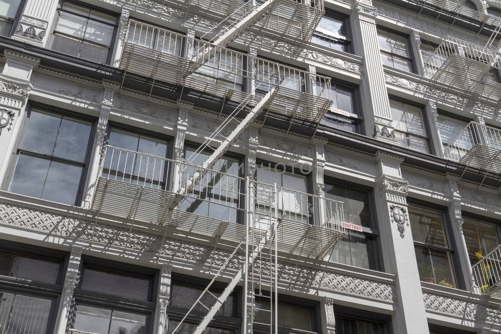 Exterior fire escape stairs on the outside of an old brick building. New York