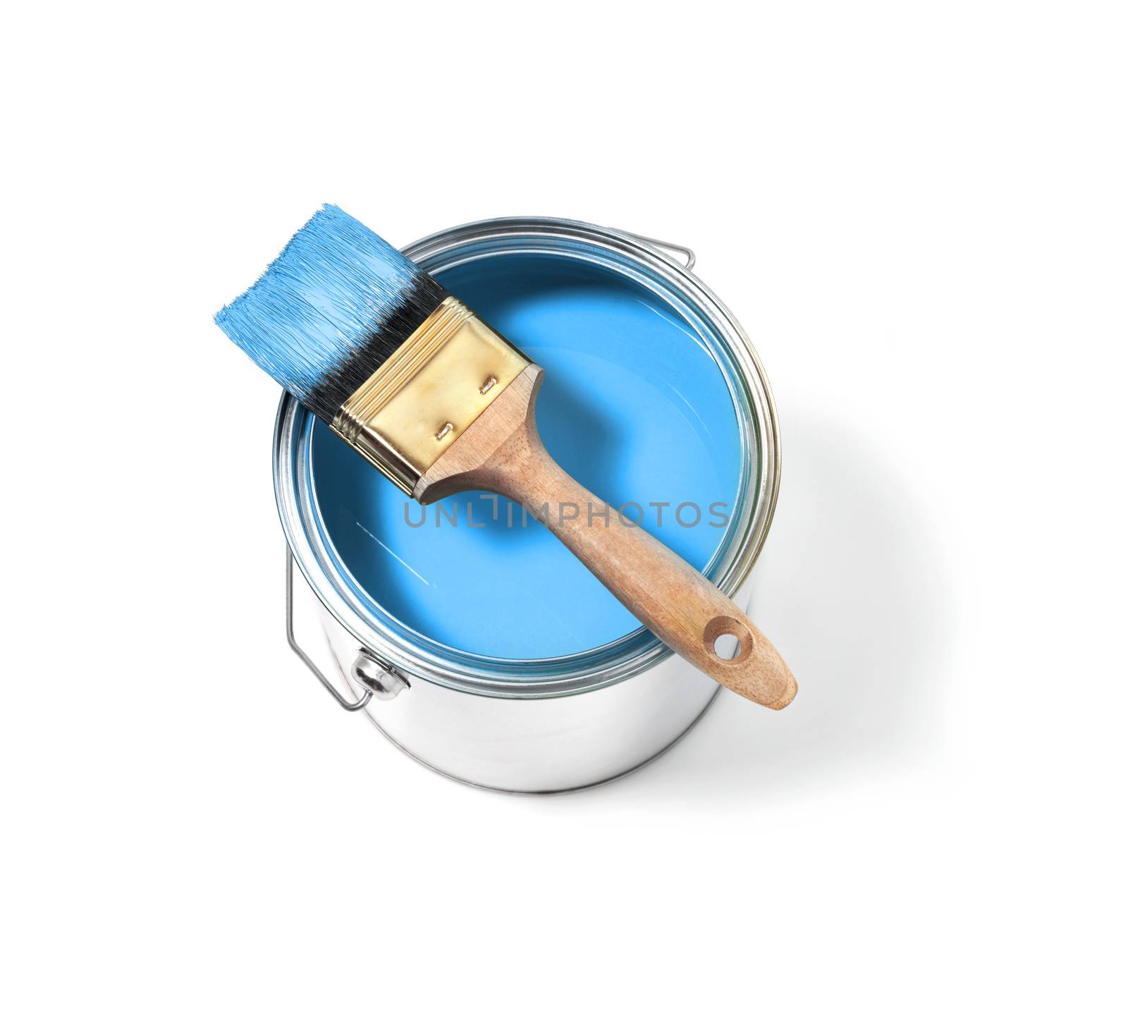 Blue paint in tin can with large brush on top on a white background