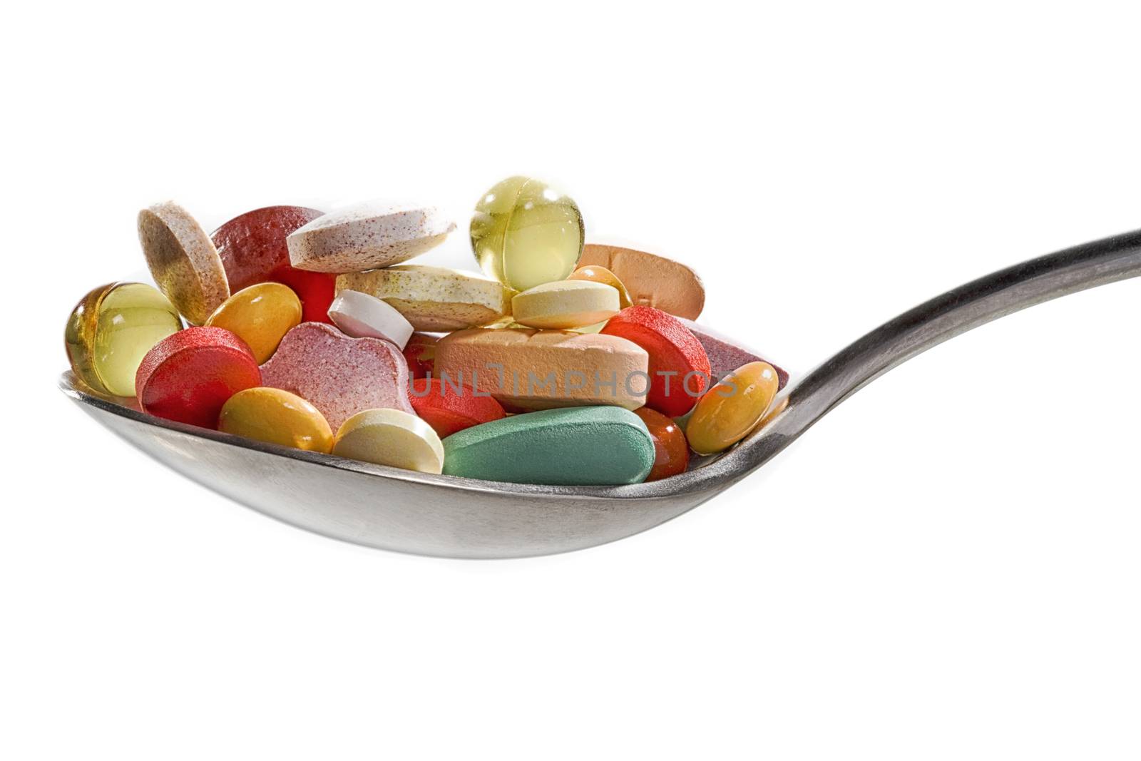 Medicine pills or capsules in a spoon. Drug prescription for treatment medication. Pharmaceutical medicament, cure in container for health. Antibiotic, painkiller closeup