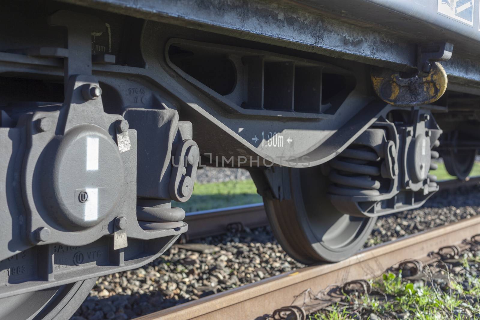 A closeup view of the wheels of a train by Tjeerdkruse