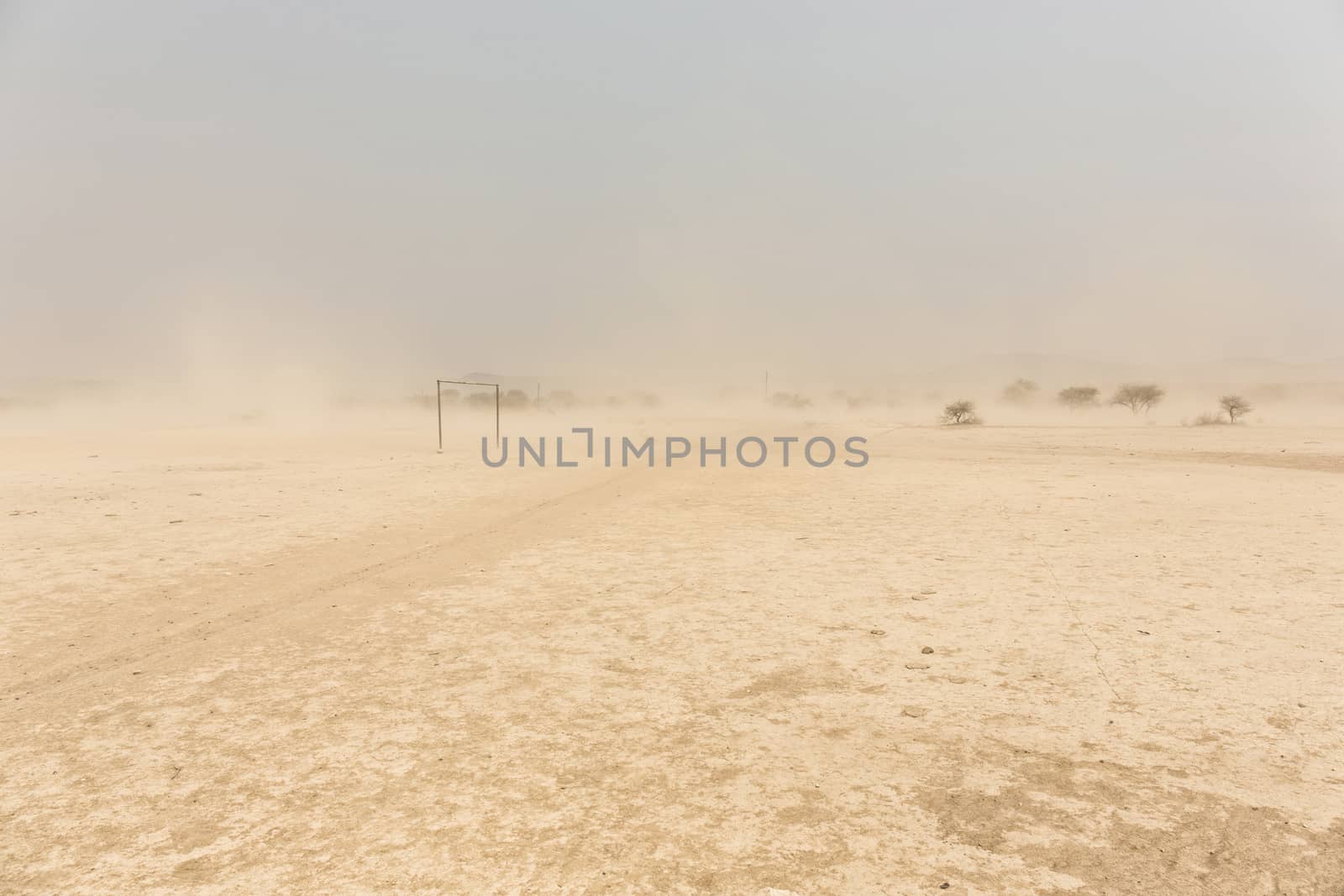 desert Soccer field in front of a white sand storm, Namibia, Afr by Tjeerdkruse