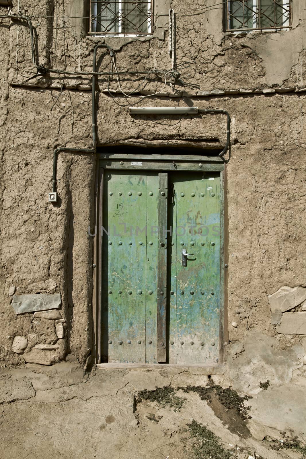 Old door in Al Hamra Yemen Village in Oman in the Middle East by Tjeerdkruse