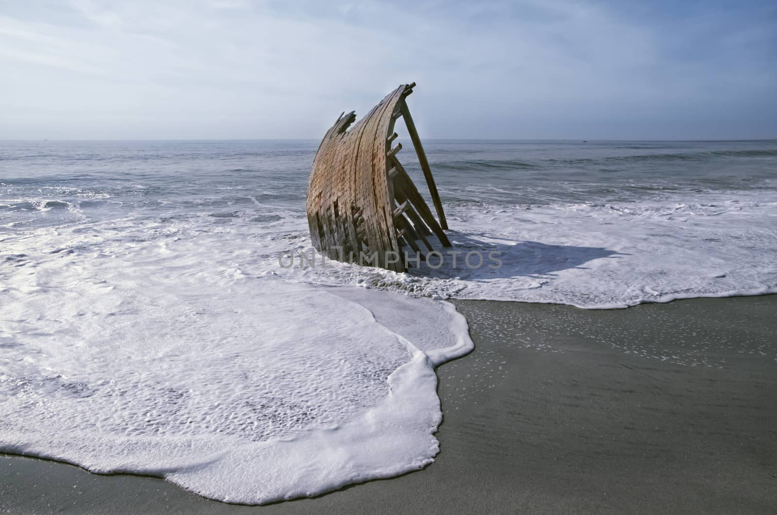 Wrecked Dhow on a beach by Tjeerdkruse