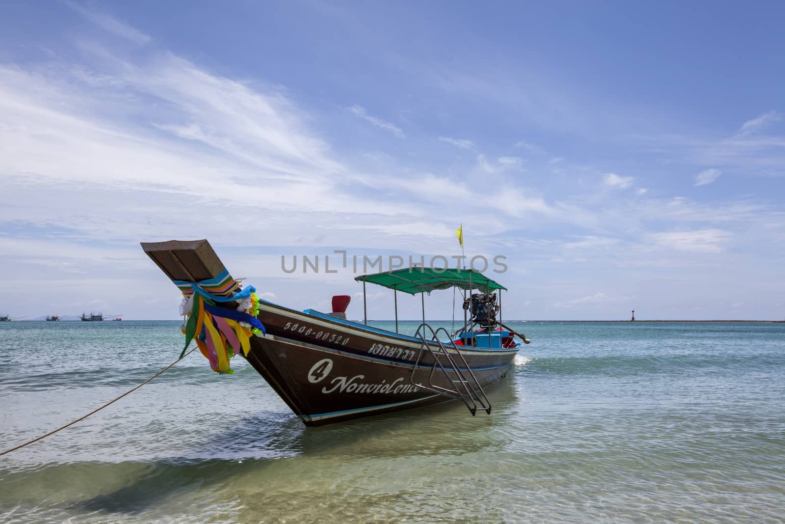 Colorful traditional Fishing boat on the sea beach at Koh pangna by Tjeerdkruse