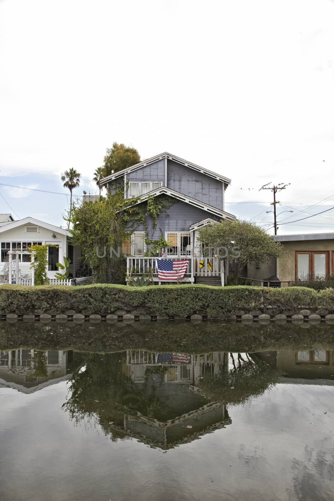 Venice Beach Canals with american flag. Travel landscape Holiday by Tjeerdkruse