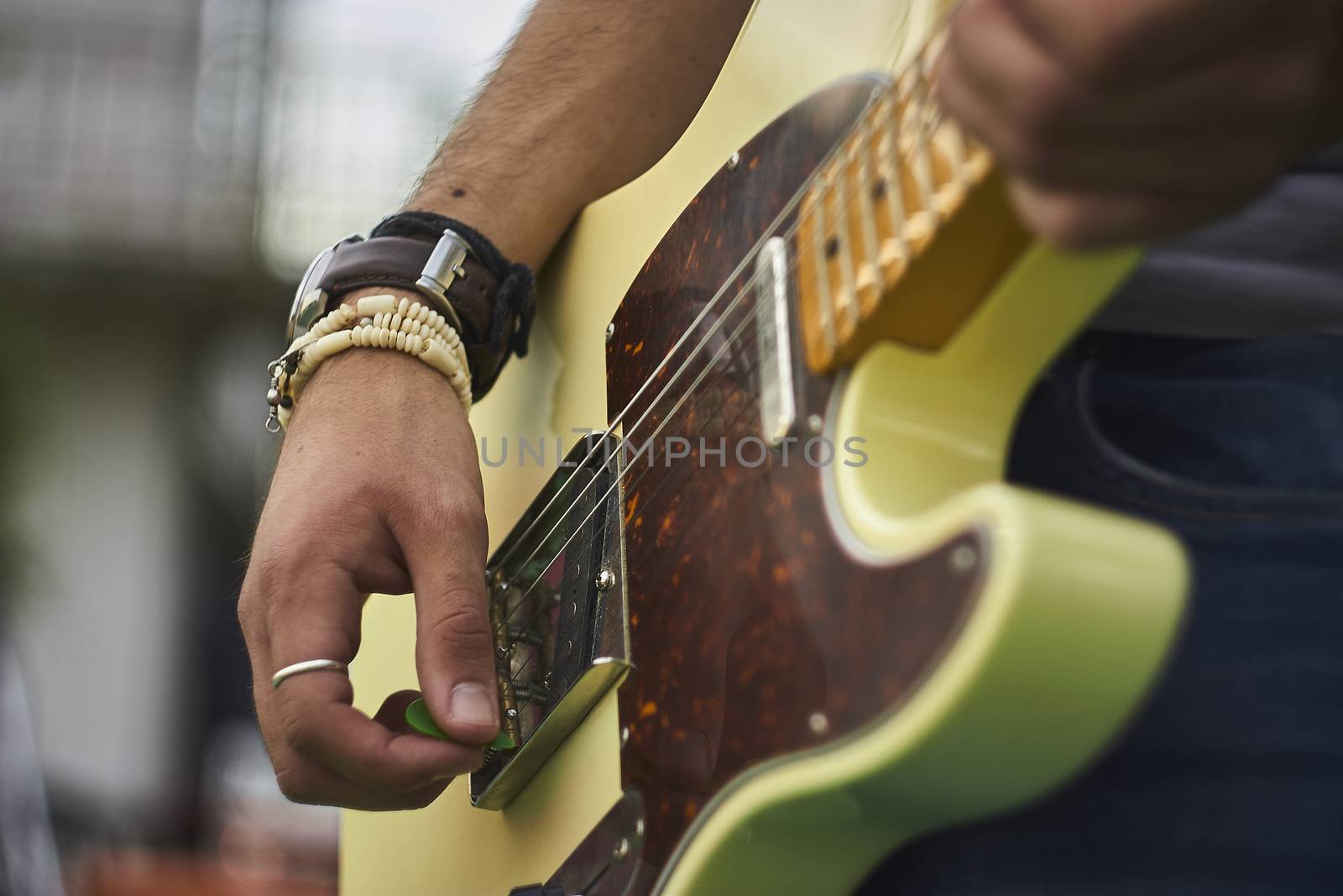 Detail of a Guitarist who plays his electric guitar at a live rock music concert.