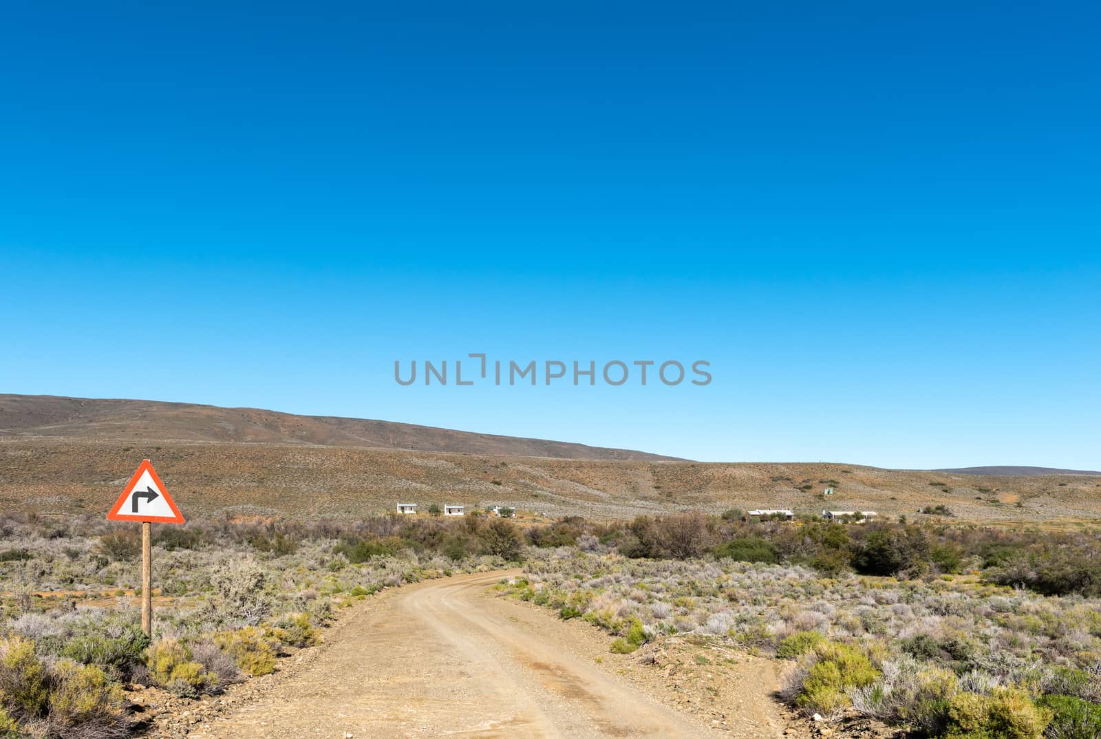 A landscape, with road sign and farm buildings, on road R356 to Ceres in the Western Cape Province