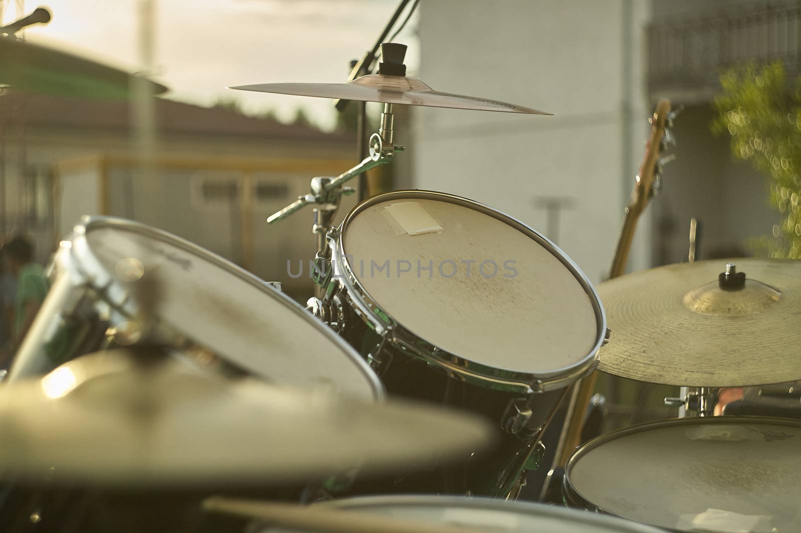 View of a drums, musical instrument, from the point of view of the player, shot in a stage ready for a live concert of a rock band.