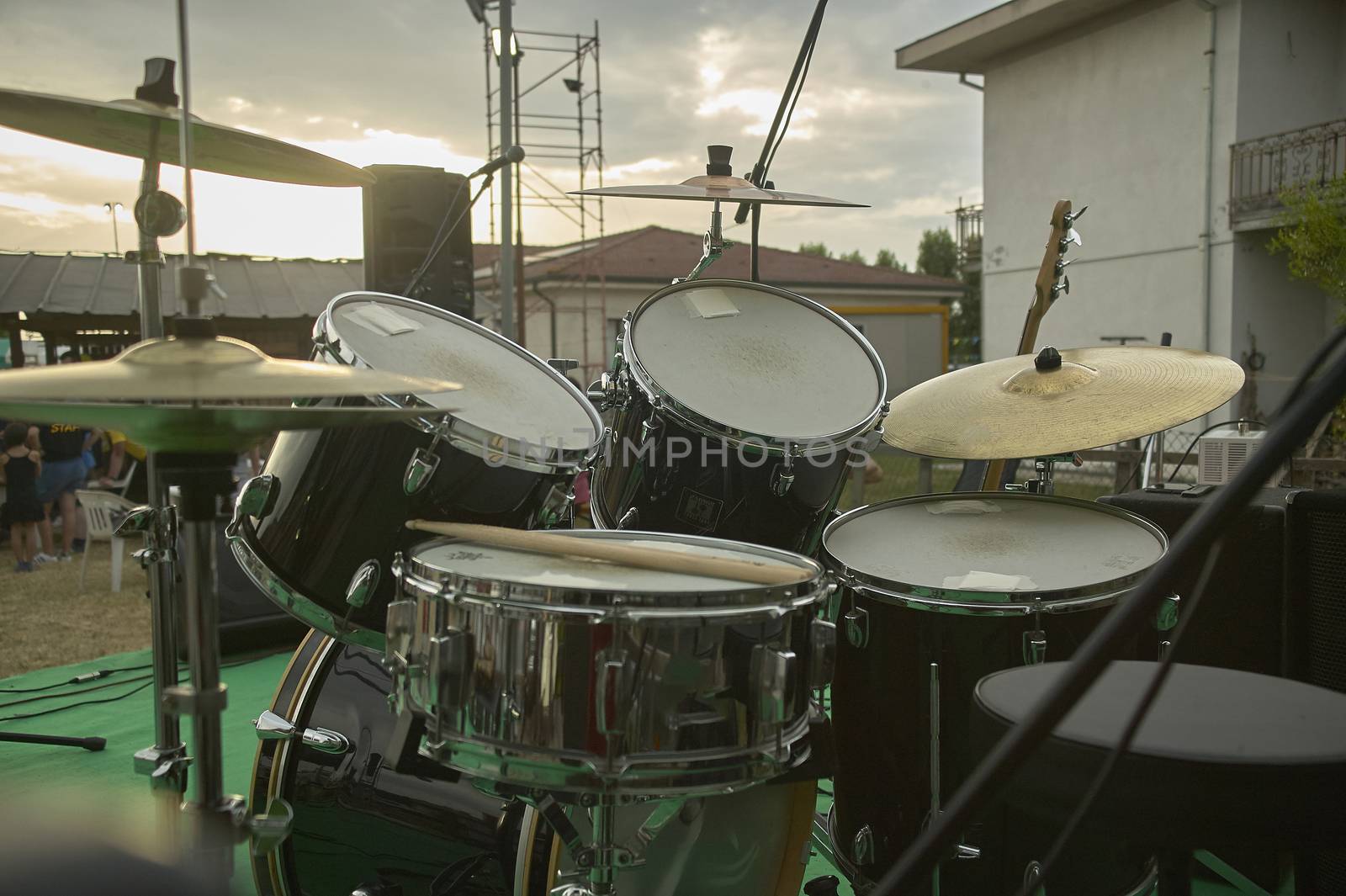 View of a drums, musical instrument, from the point of view of the player, shot in a stage ready for a live concert of a rock band.