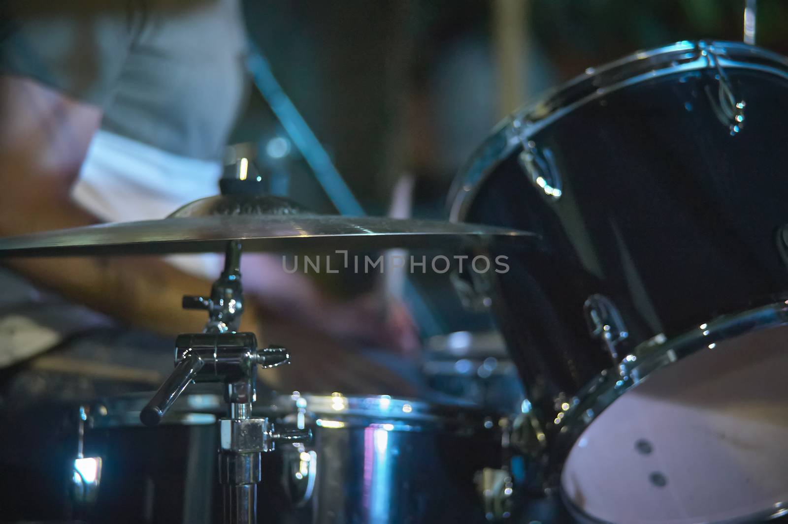 View of a drums, musical instrument, from the point of view of the player, shot in a stage ready for a live concert of a rock band.