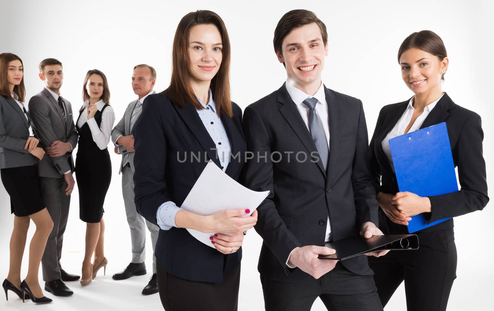 Portrait of business leaders and their team on white background