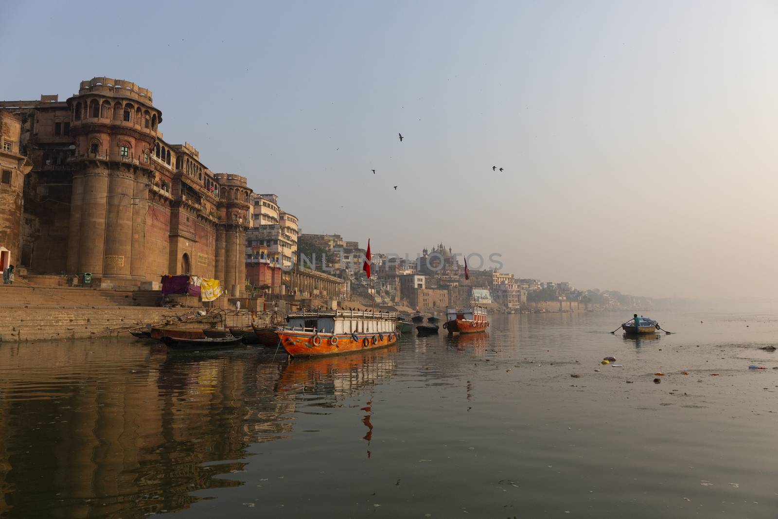 Morning view of Ganges river in Varanasi, India. Ghats with boats and people. Popular landmark, Varanasi, India
