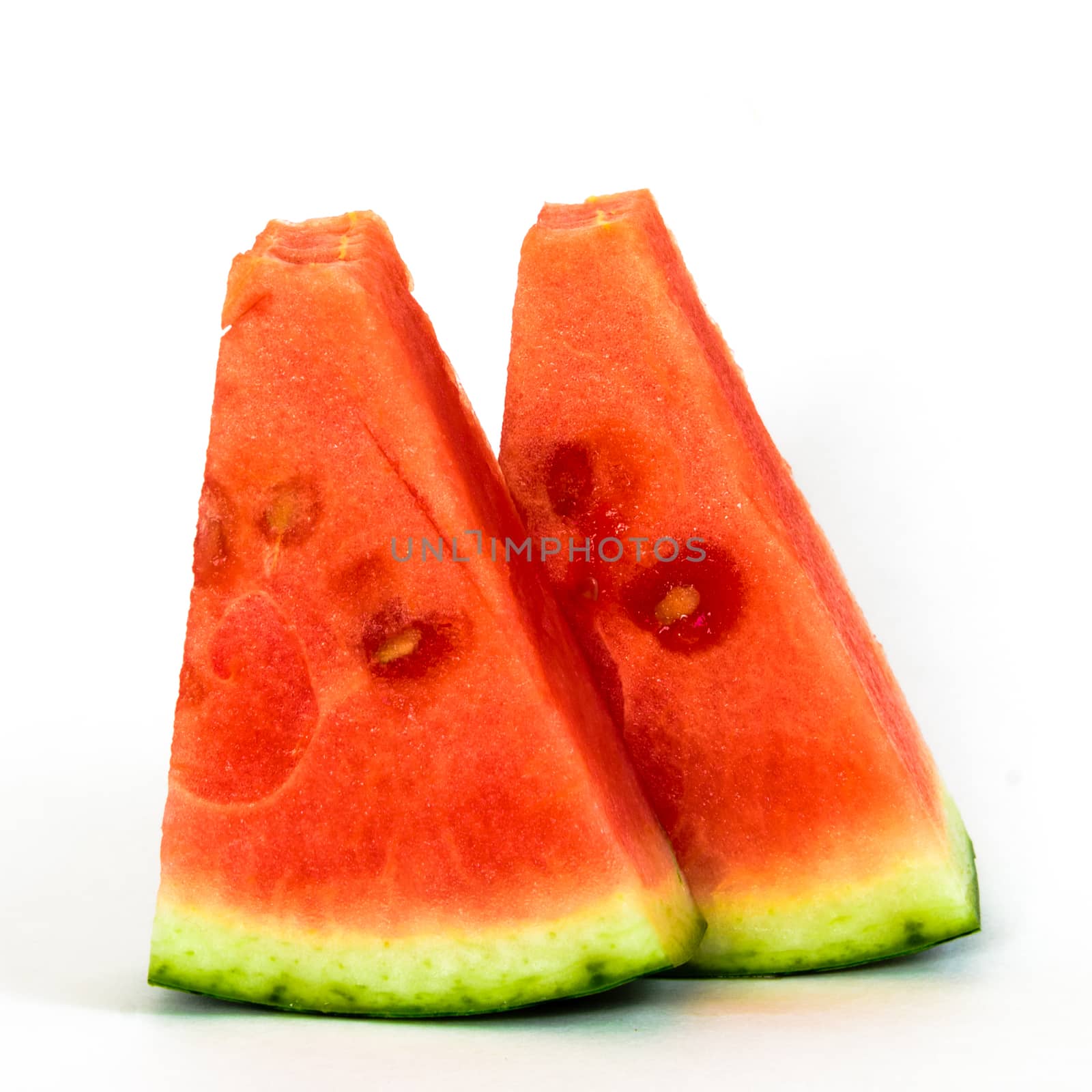 Studio shot two small slice cuts of mini organic watermelon isolate on white by trongnguyen