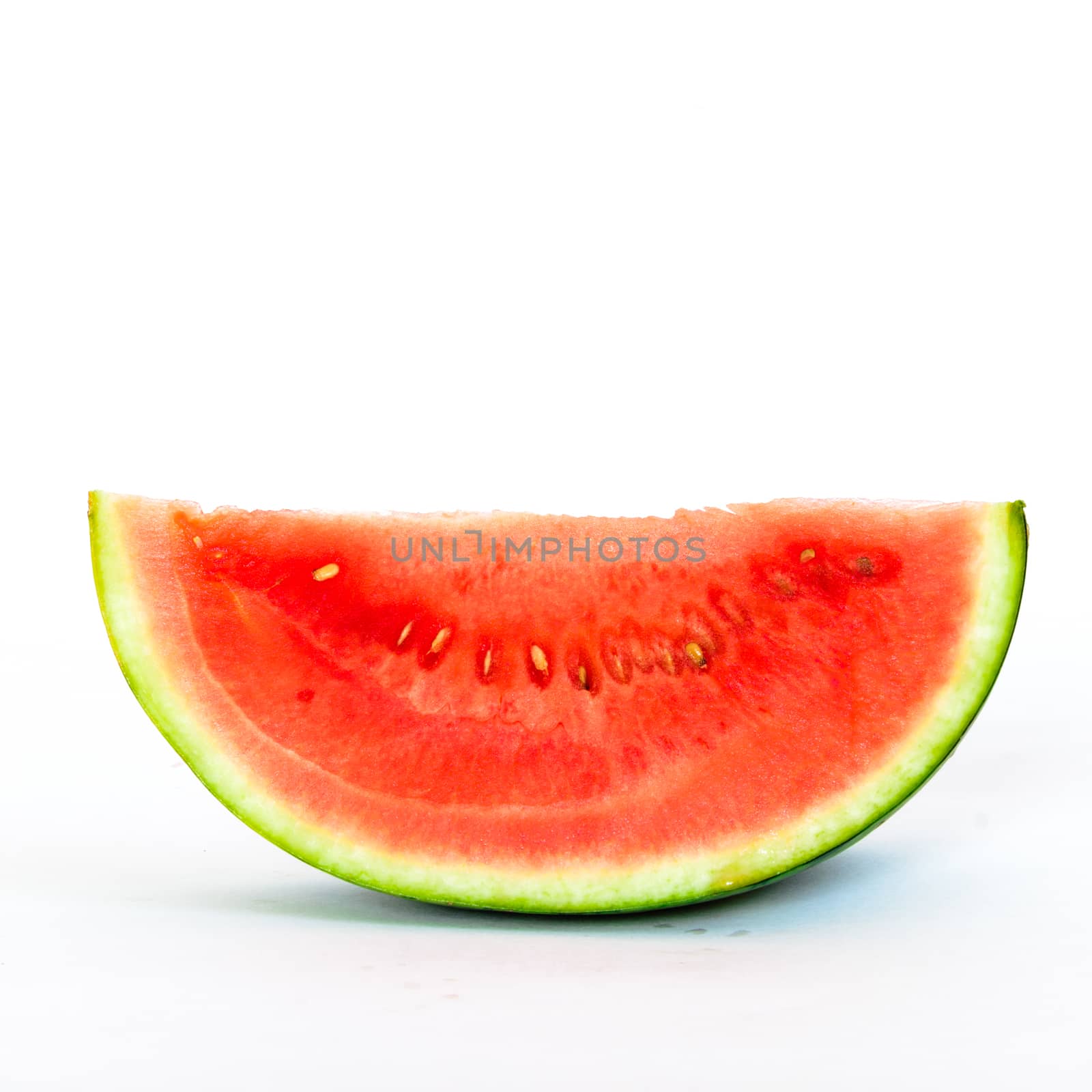 Studio shot single slice cut of mini organic watermelon isolate on white by trongnguyen