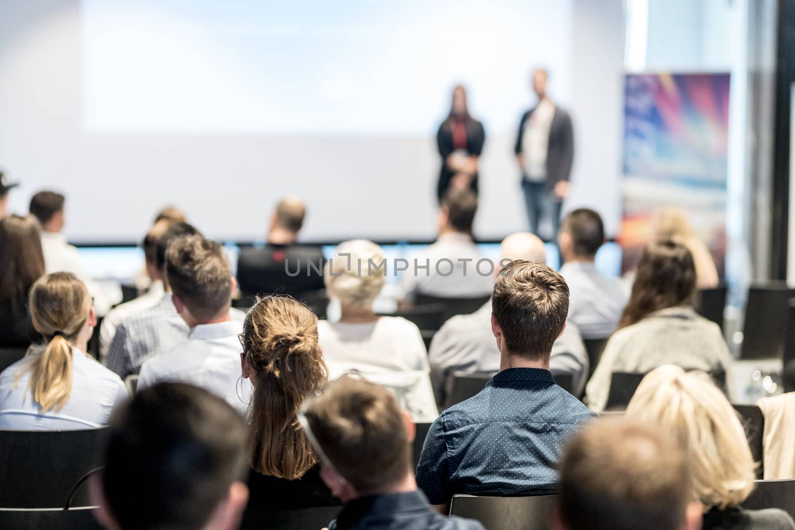 Male business speaker giving a talk at business conference event. by kasto
