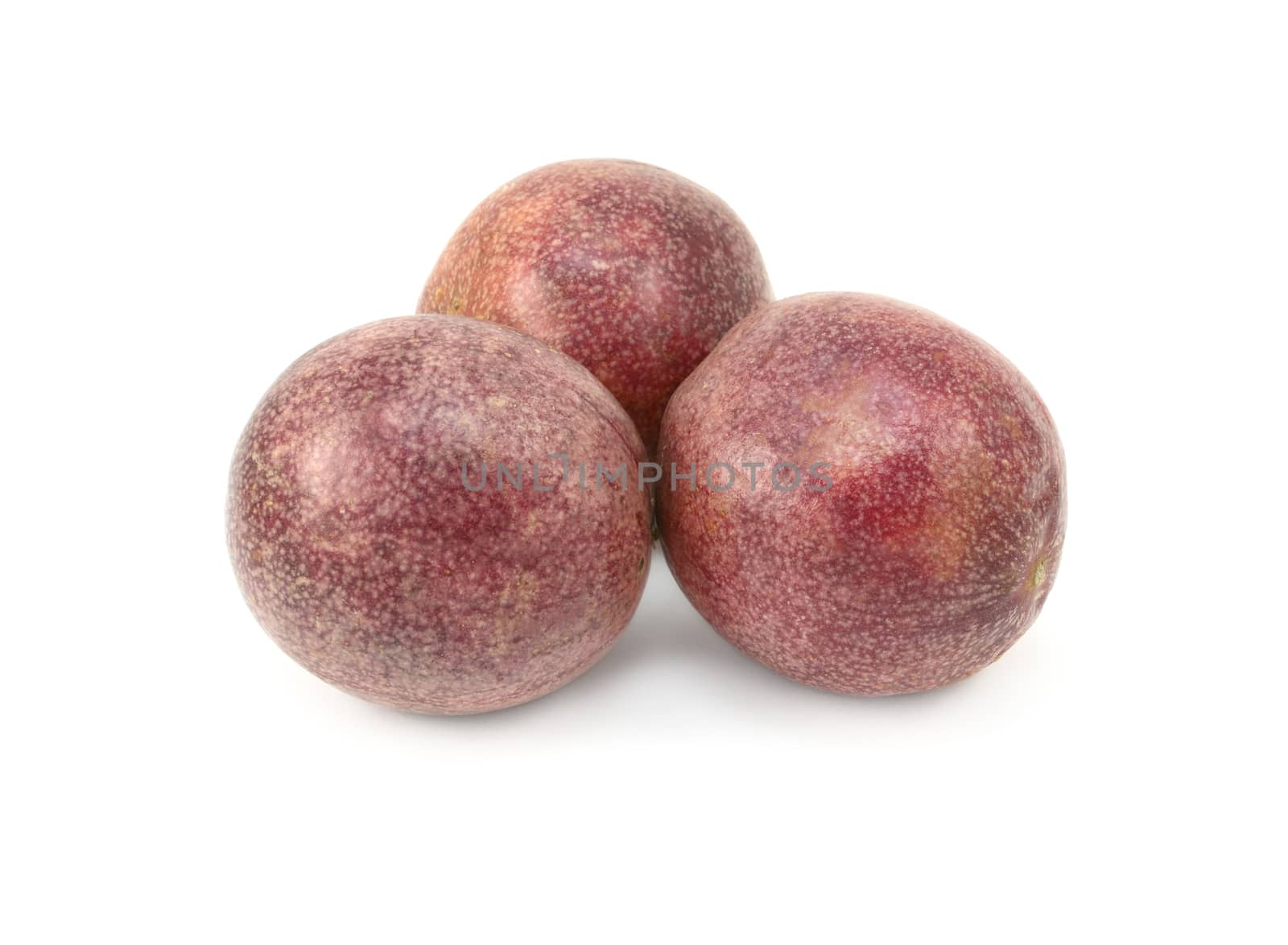 Three whole passion fruits with speckled purple skins by sarahdoow